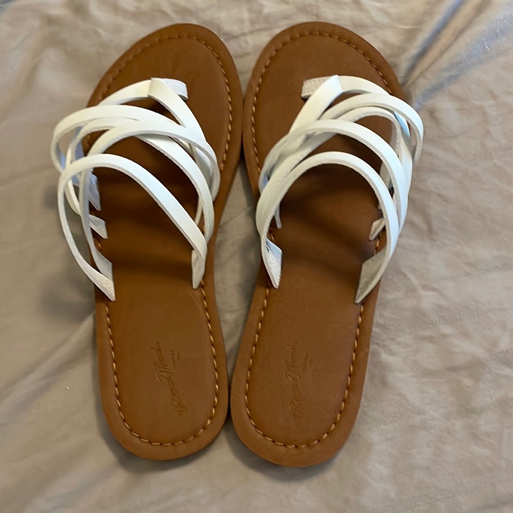 White and tan flip flops